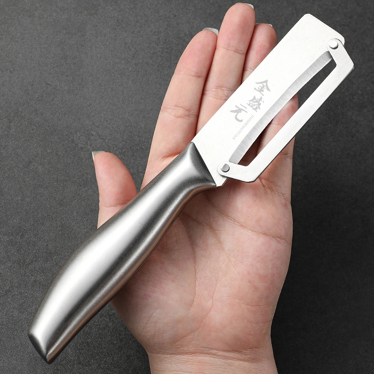 Maison Verdane stainless steel peeler with bottle opener, featuring a wooden or steel handle for efficient kitchen use.