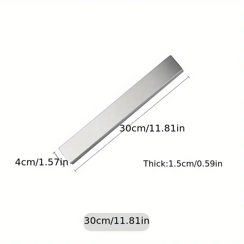 Stainless steel magnetic knife holder from Maison Verdane mounted on kitchen wall, holding knives securely.