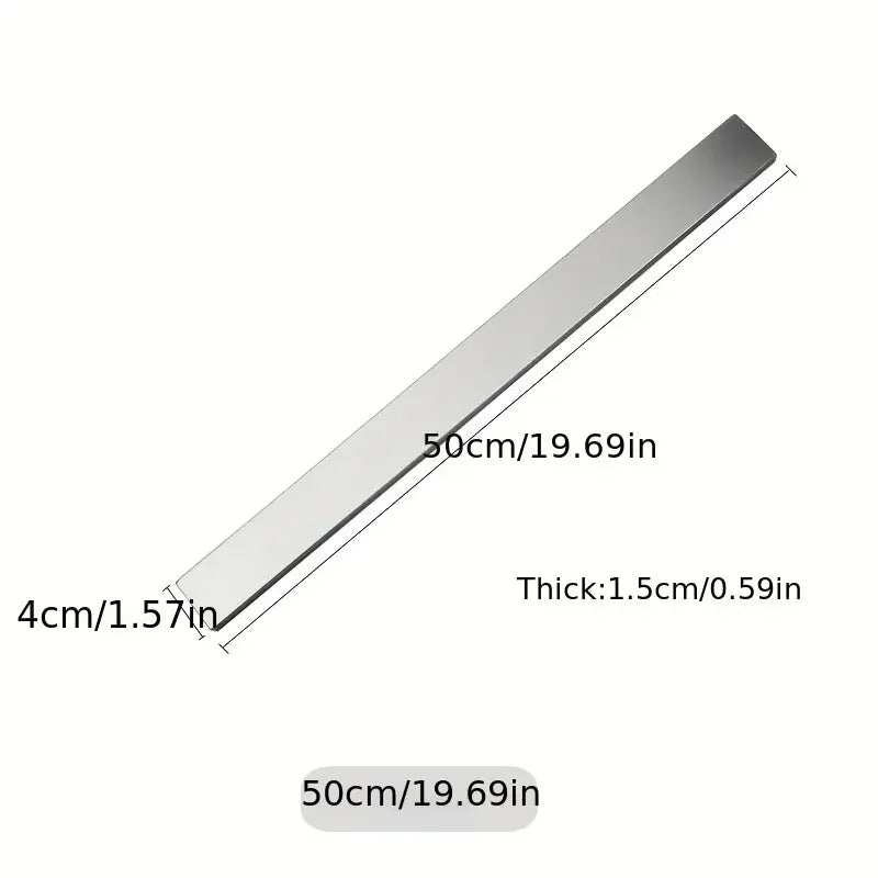 Stainless steel magnetic knife holder wall mount by Maison Verdane holding kitchen knives securely in a modern kitchen.